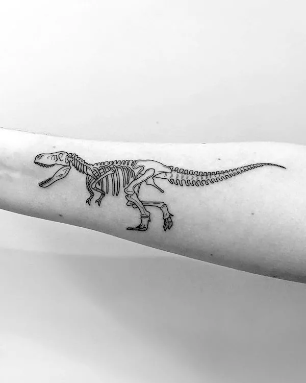 Black and grey T-rex skeleton tattoo by @stephen_doyle_tattoo