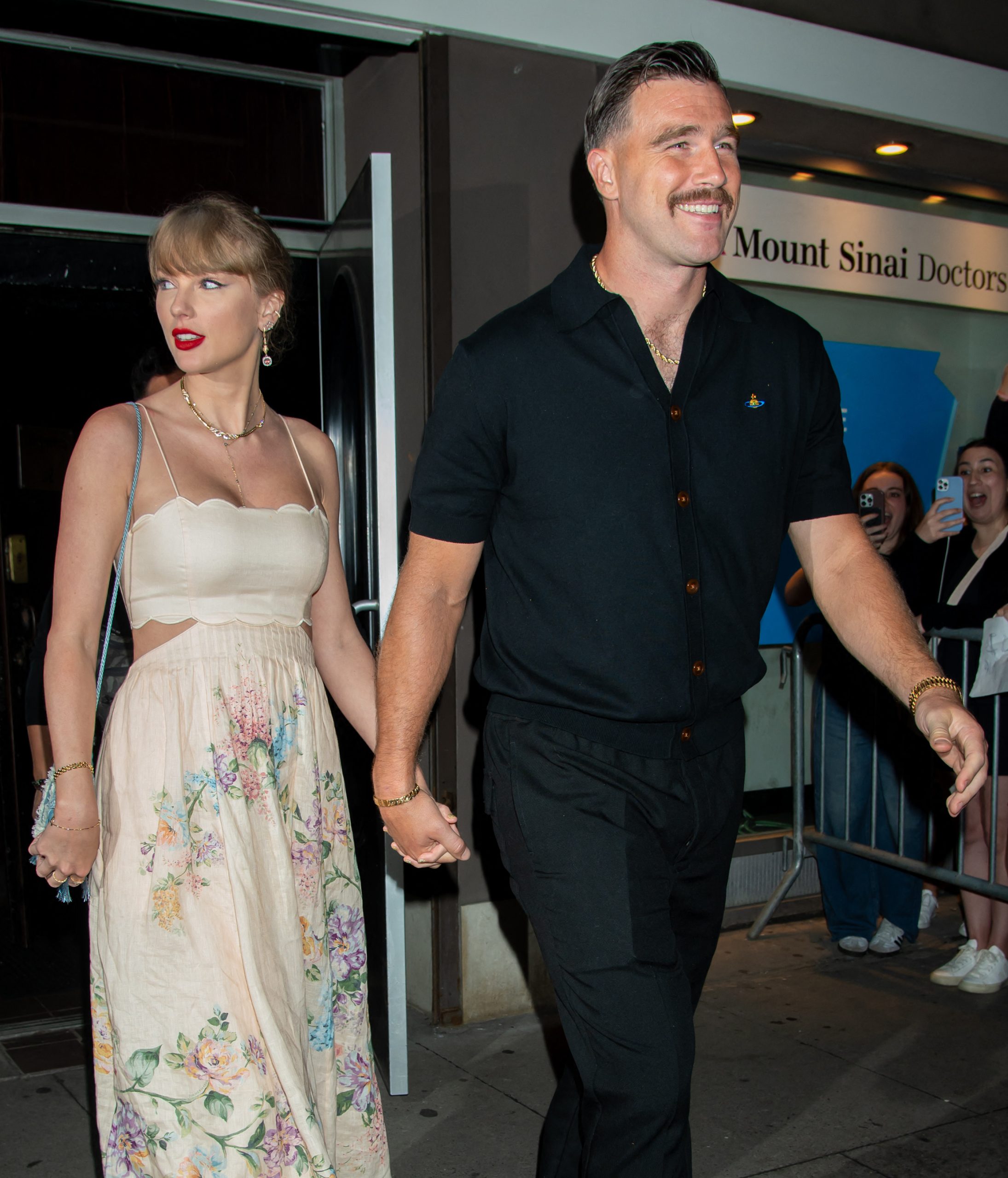 Taylor Swift and Travis Kelce holding hands