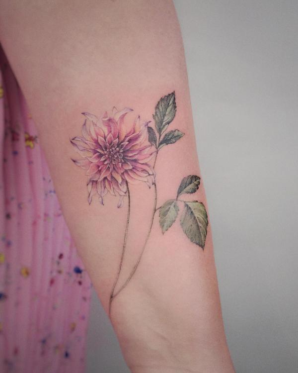 Feminine dahlia flower forearm tattoo