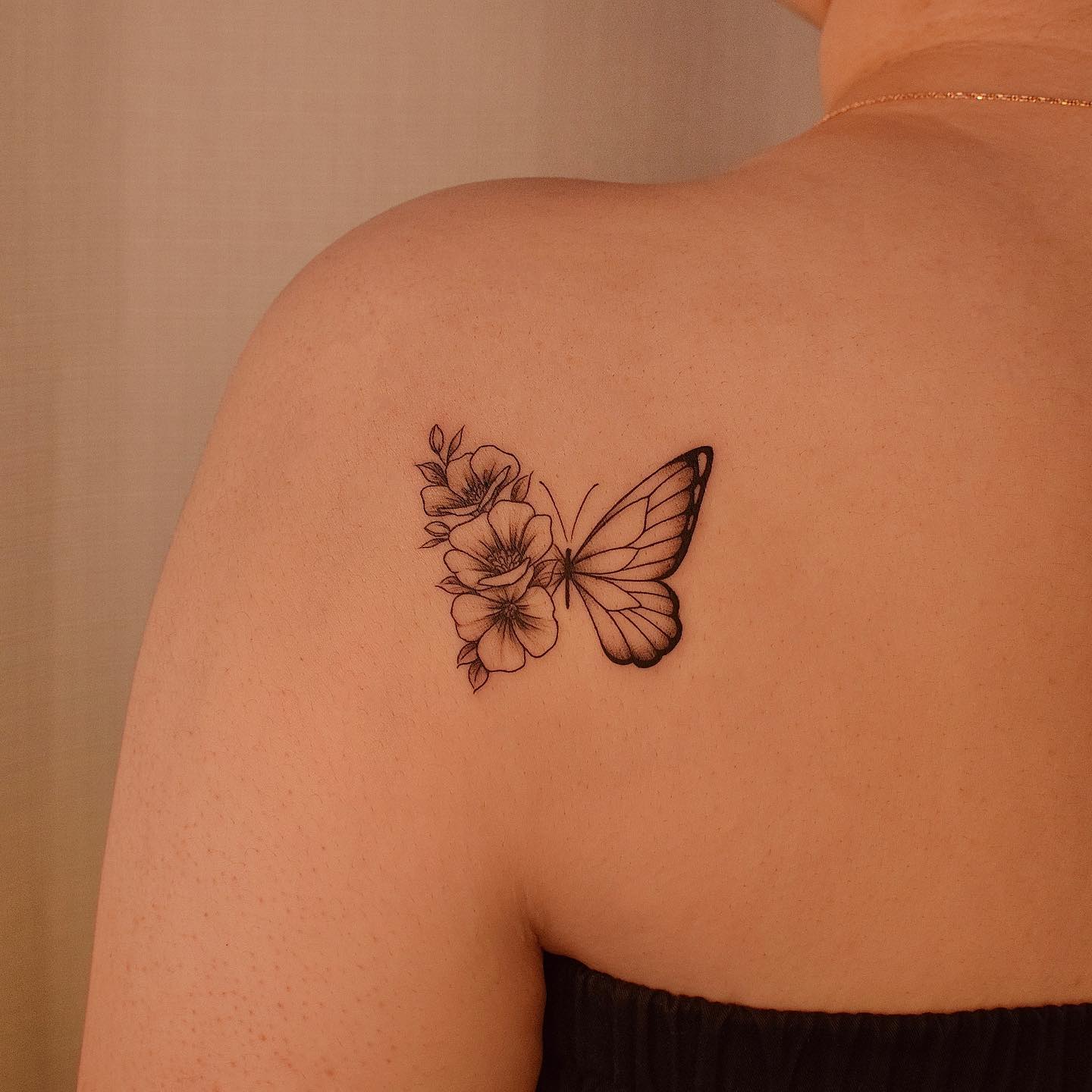 Half butterfly and half flowers tattoo on the back shoulder