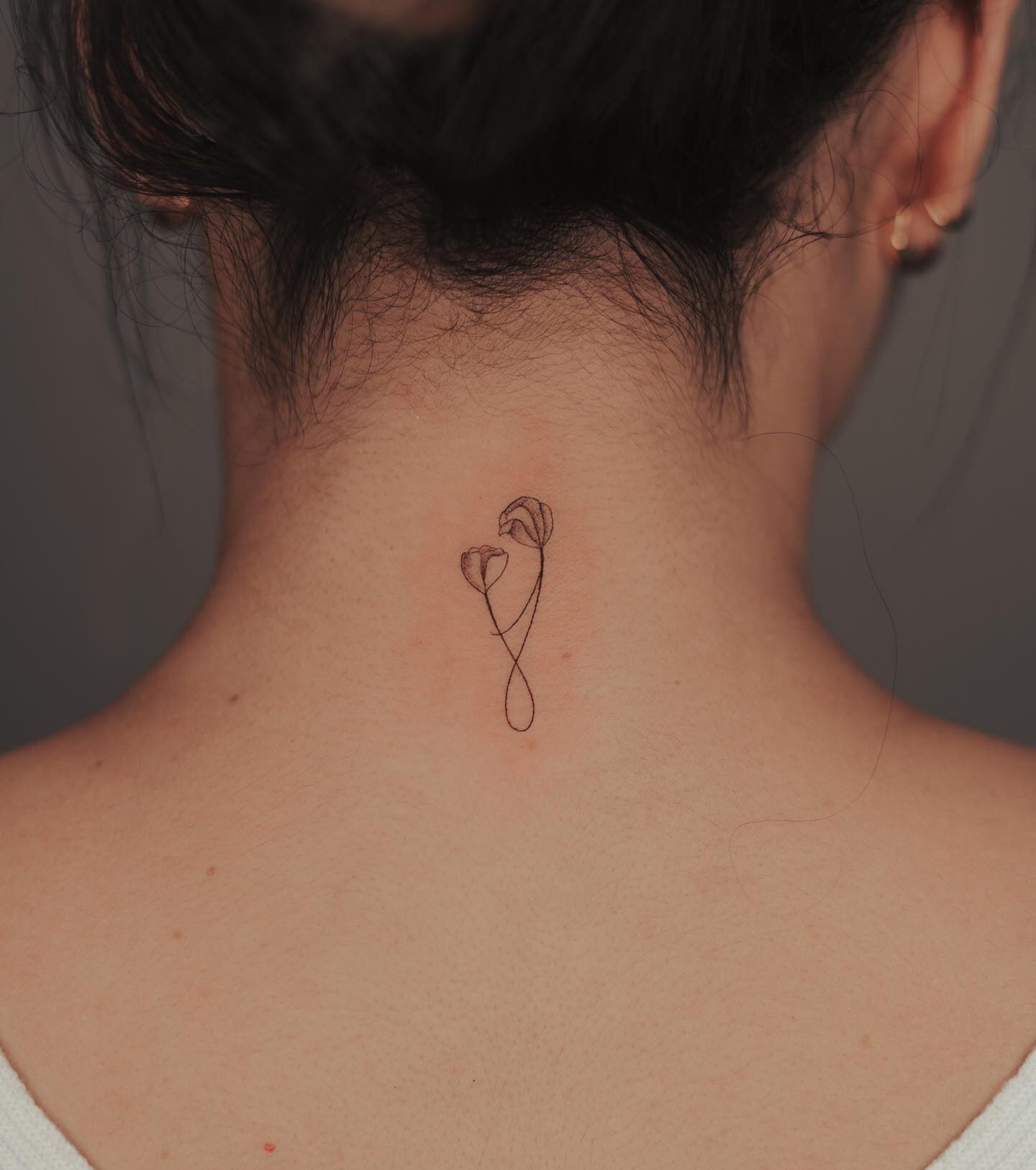 Floral mother and daughter symbol tattoo on the nape