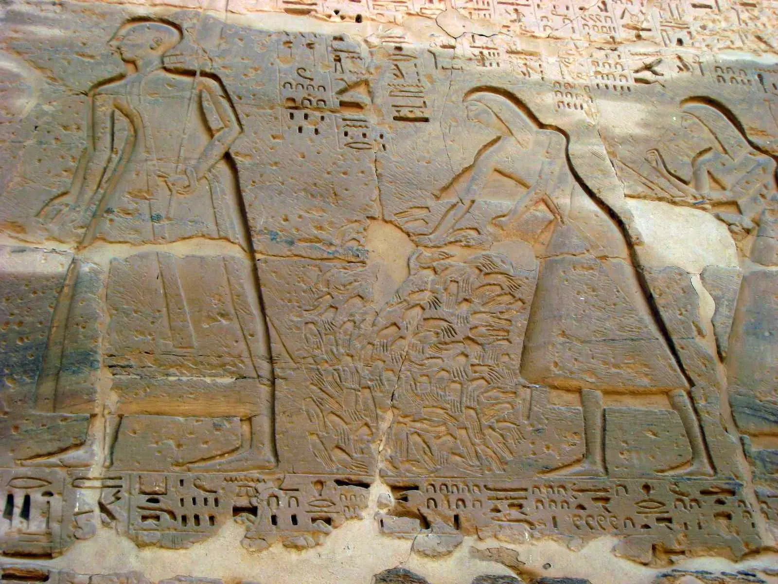 This image was created about 400 years after the Avaris hands were deposited. It shows the chopped-off hands of enemy soldiers being prepared for Ramses III, a pharaoh of Egypt, after a successful campaign.