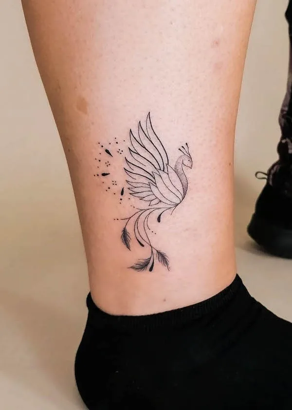 Small ornamental phoenix on the ankle by @kimkoss.ink