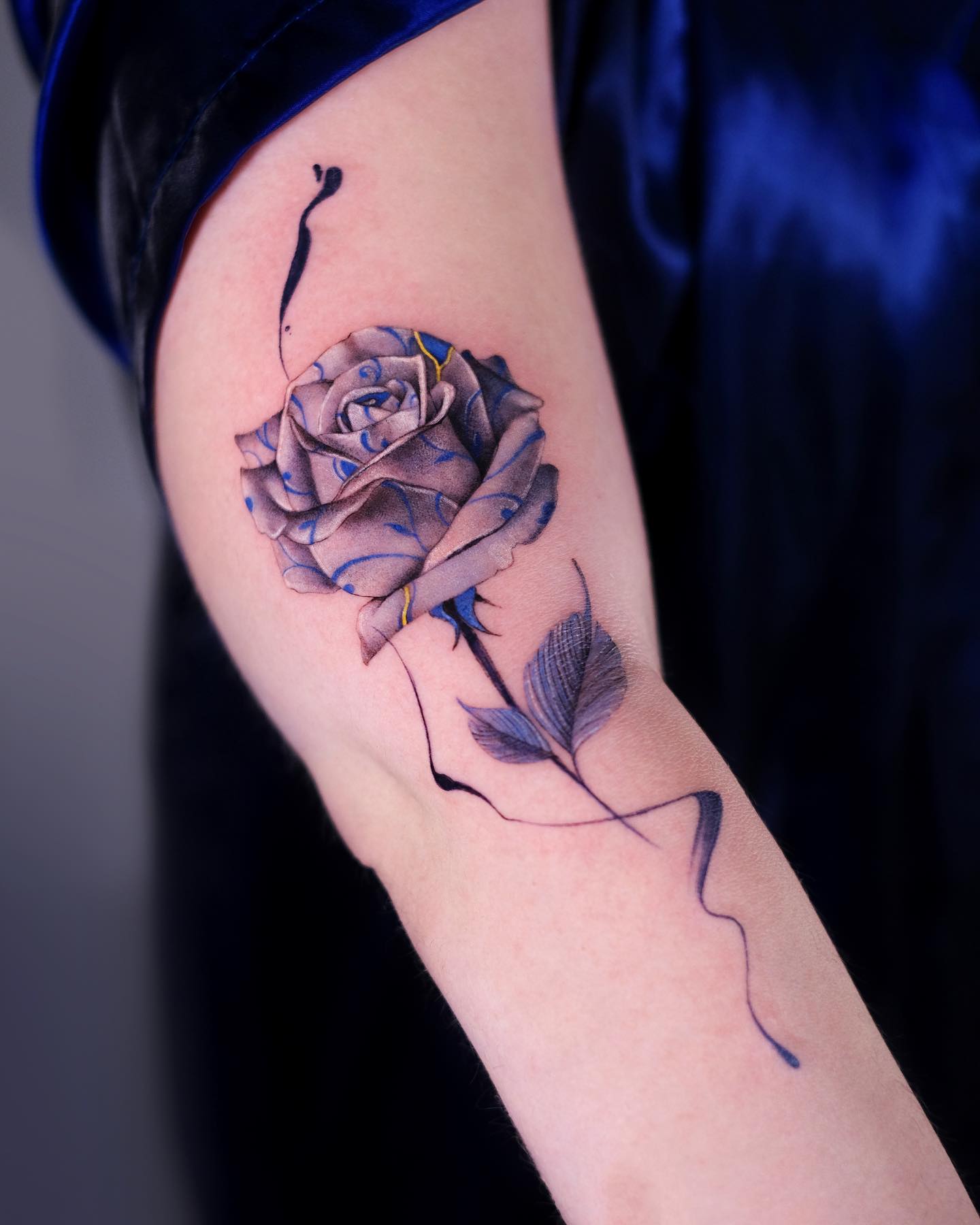 Porcelain rose tattoo located on the arm