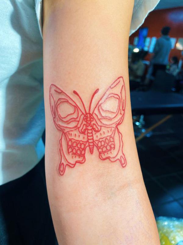 Fine line red skull butterfly tattoo