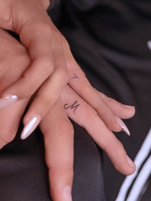 Simple initials on the ring finger by @tattooboutiquelarissa