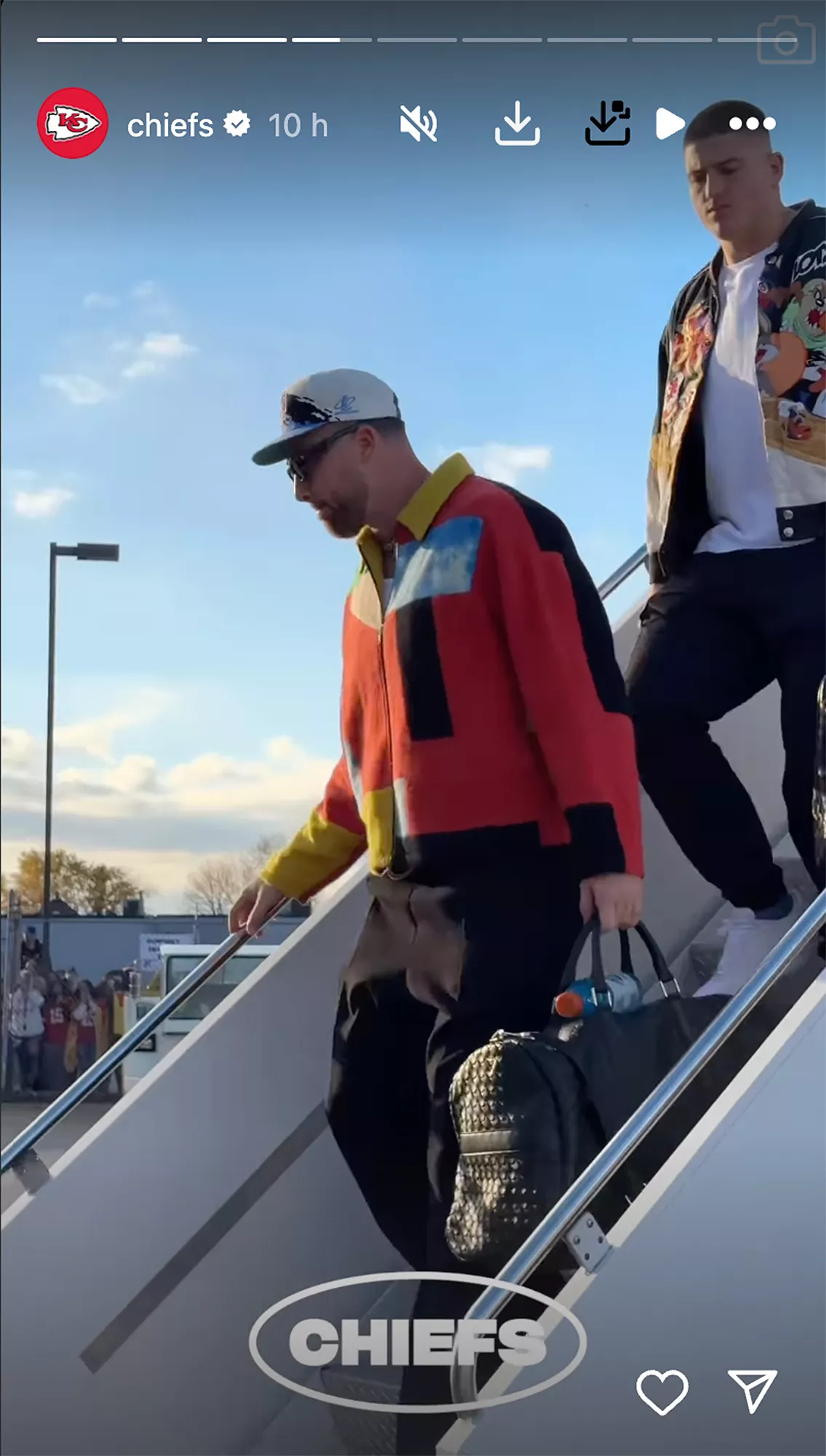 Travis Kelce Arrives in Buffalo in Bold Multi-Colored Jacket and Cavs Baseball Cap Ahead of Chiefs-Bills Matchup