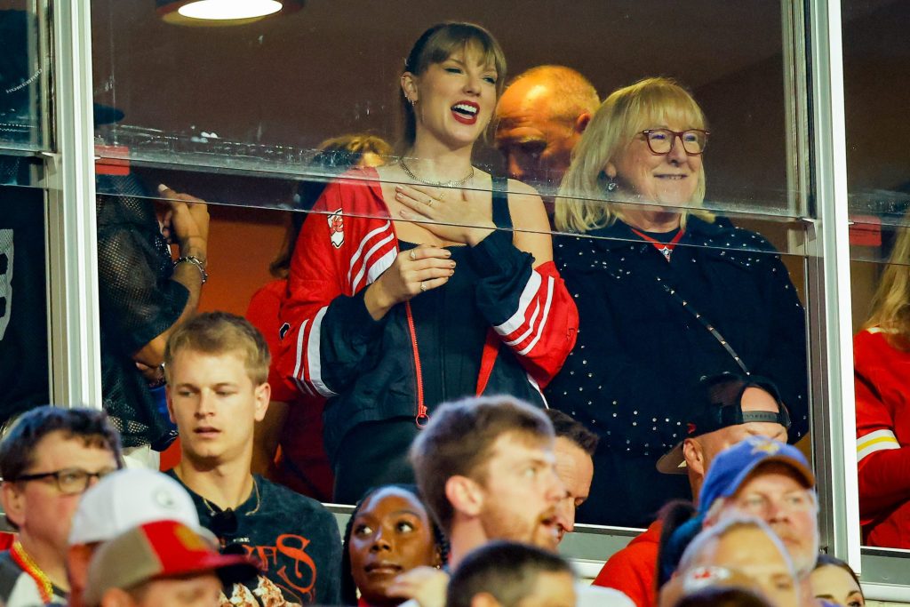 Taylor Swift and Donna Kelce in conversation at a Kansas City Chiefs vs Denver Broncos game, October 12, 2023