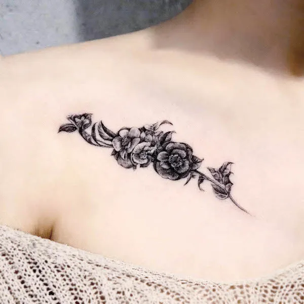 Black camellia flower collarbone tattoo by @forest__tt