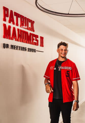 <p>Texas Tech Athletics</p> Patrick Mahomes poses in front of the quarterback meeting room named after him