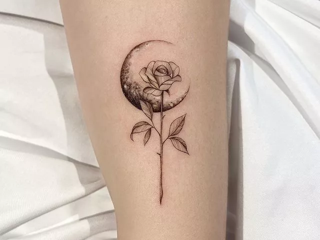 crescent moon and long stem rose tattoo