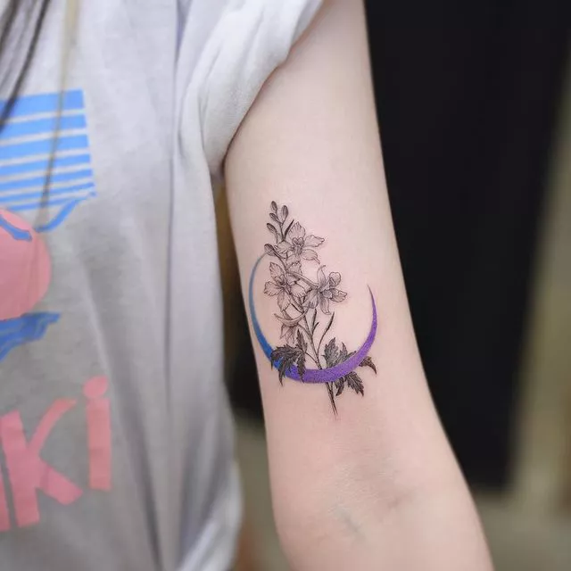 crescent moon with birth flower tattoo