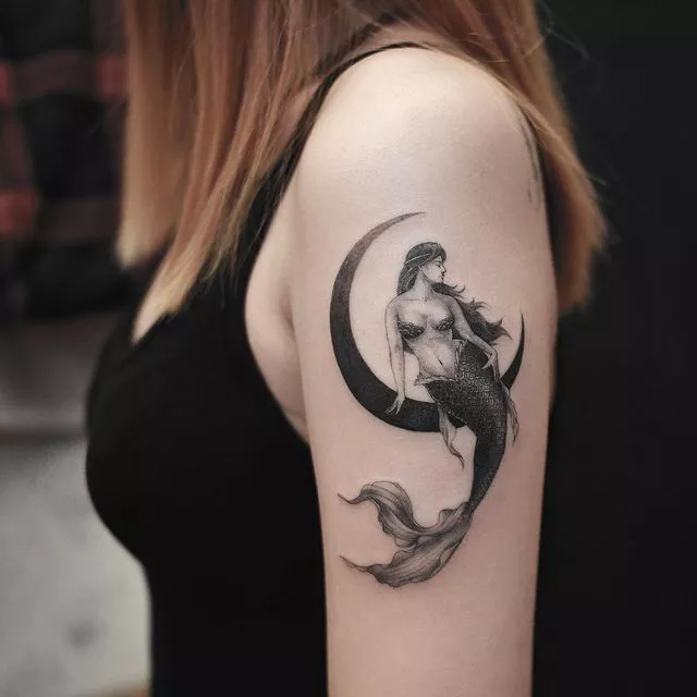 mermaid sitting on a crescent moon tattoo