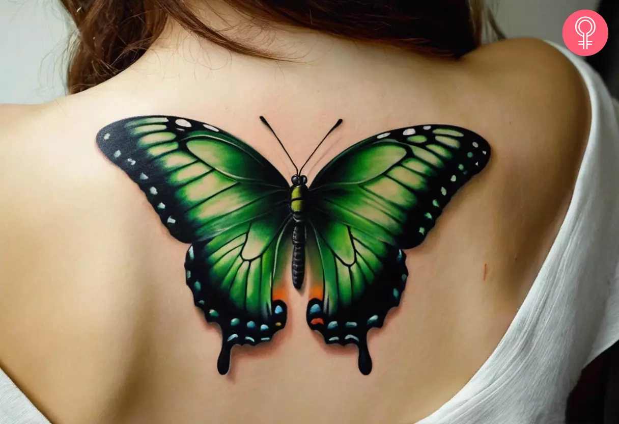 A 3D butterfly drawing tattoo on a woman’s back