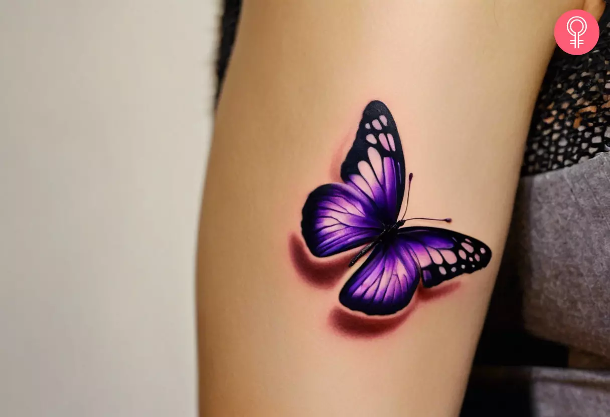 A purple 3D butterfly tattoo on a woman’s arm