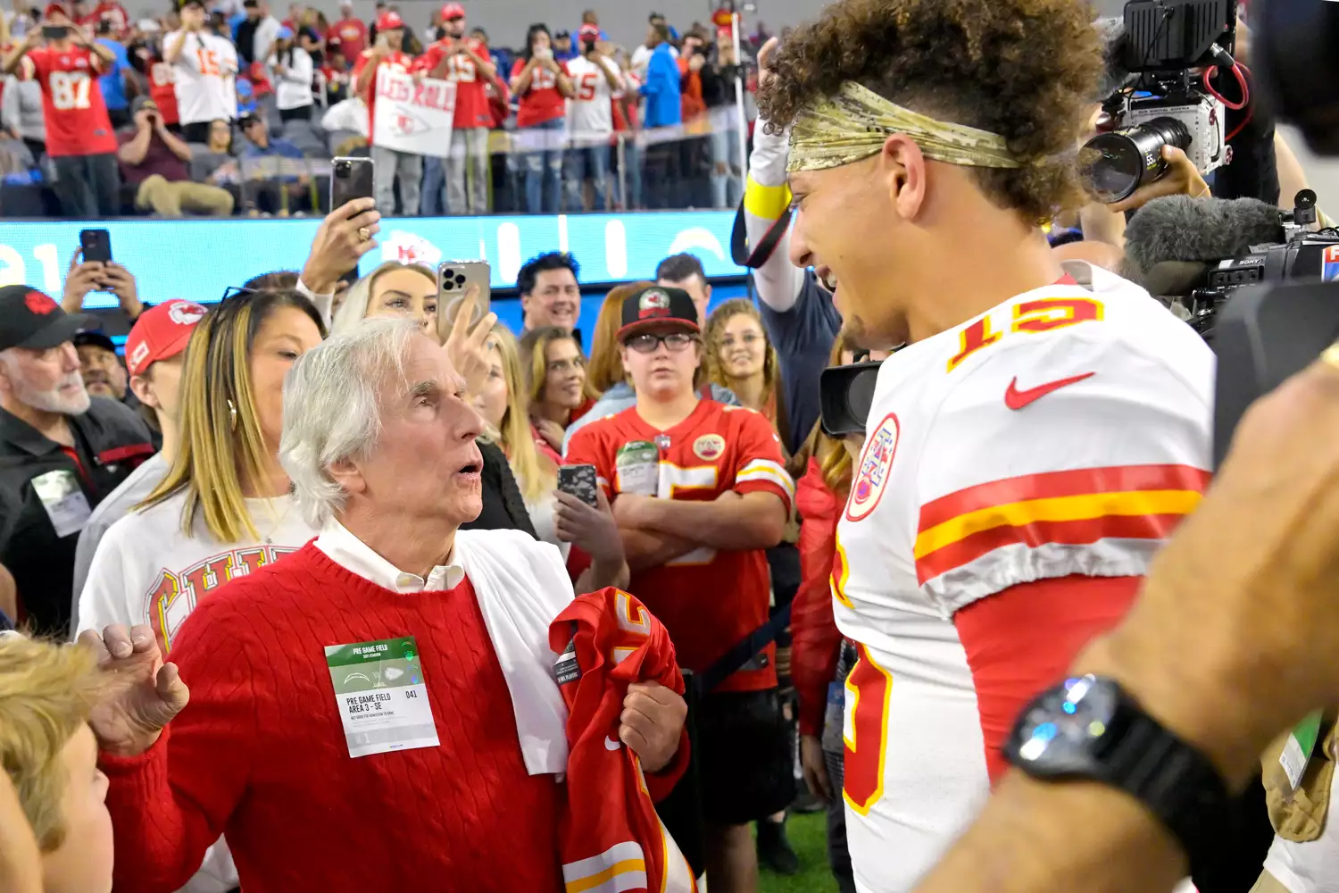 Actor Henry Winkler, left, speaks with Kansas City Chiefs quarterback Patrick Mahomes prior to an NFL football game between Chiefs and the Los Angeles Chargers Sunday, Nov. 20, 2022, in Inglewood, Calif. 