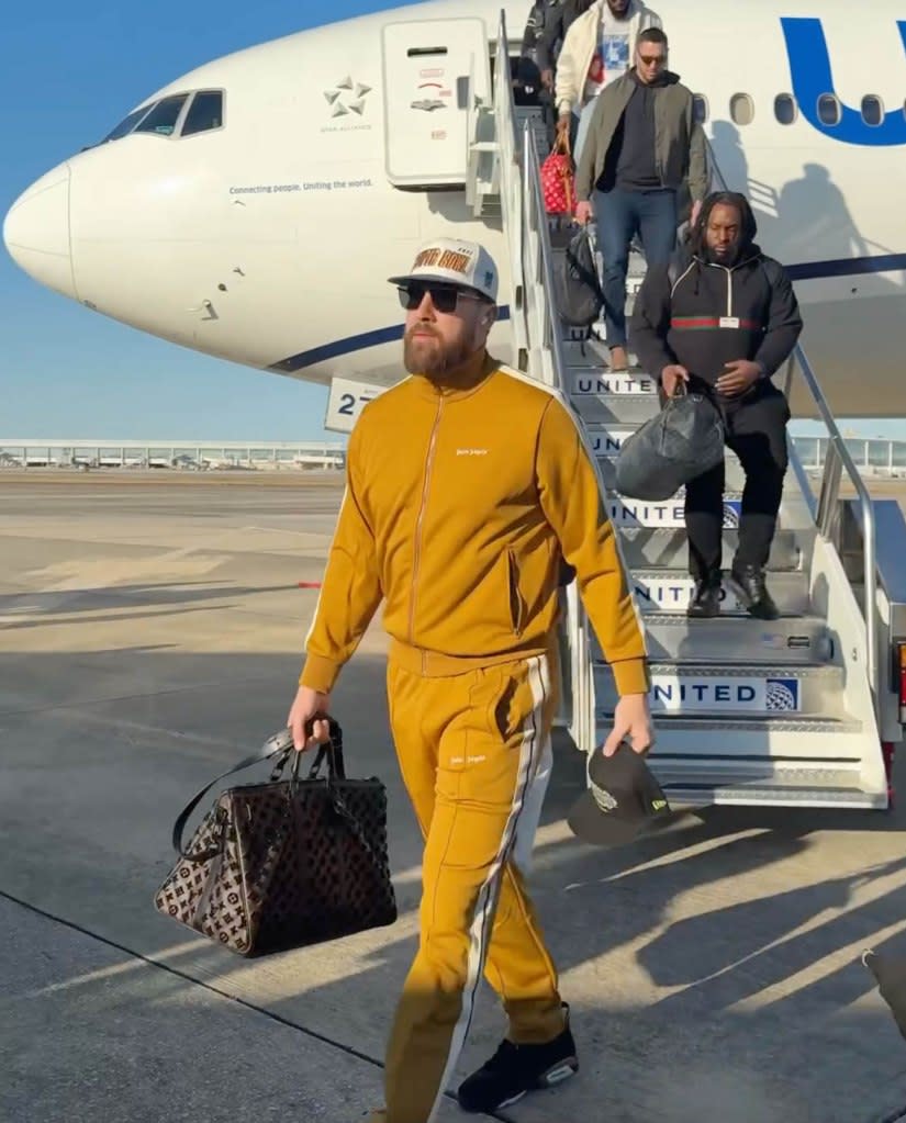 Kelce wore a gold jacket with matching pants, accessorizing with a Louis Vuitton bag and vintage hat. chiefs/Instgram