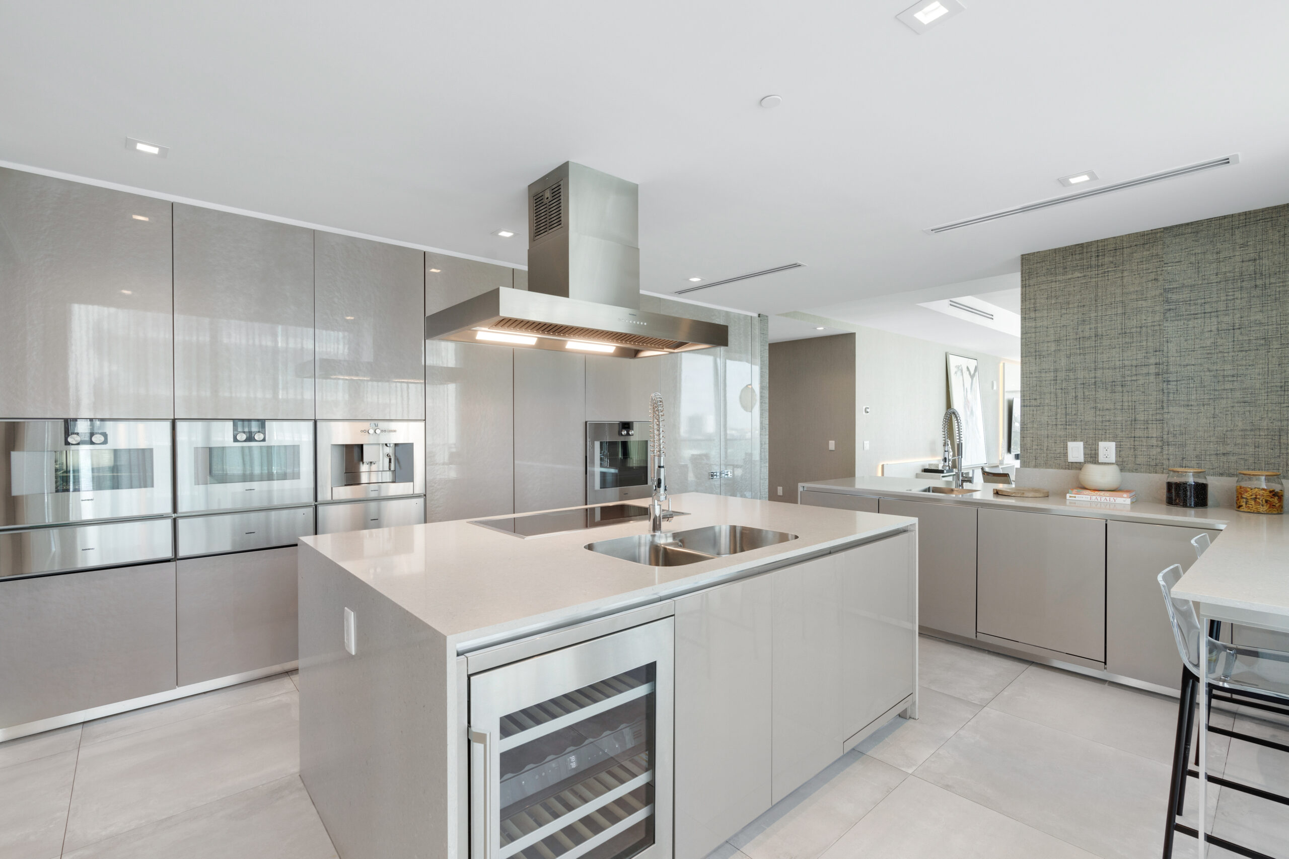 The kitchen has a wine fridge and a breakfast bar overlooking Surfside