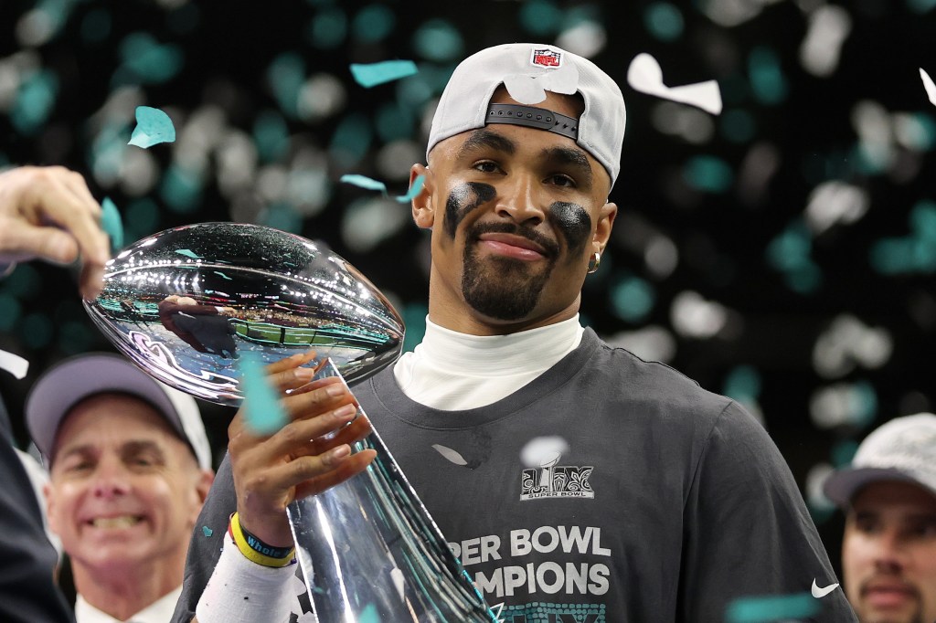 Jalen Hurts, quarterback for the Philadelphia Eagles, celebrates his 2025 Super Bowl win holding the Vince Lombardi Trophy after defeating the Kansas City Chiefs.