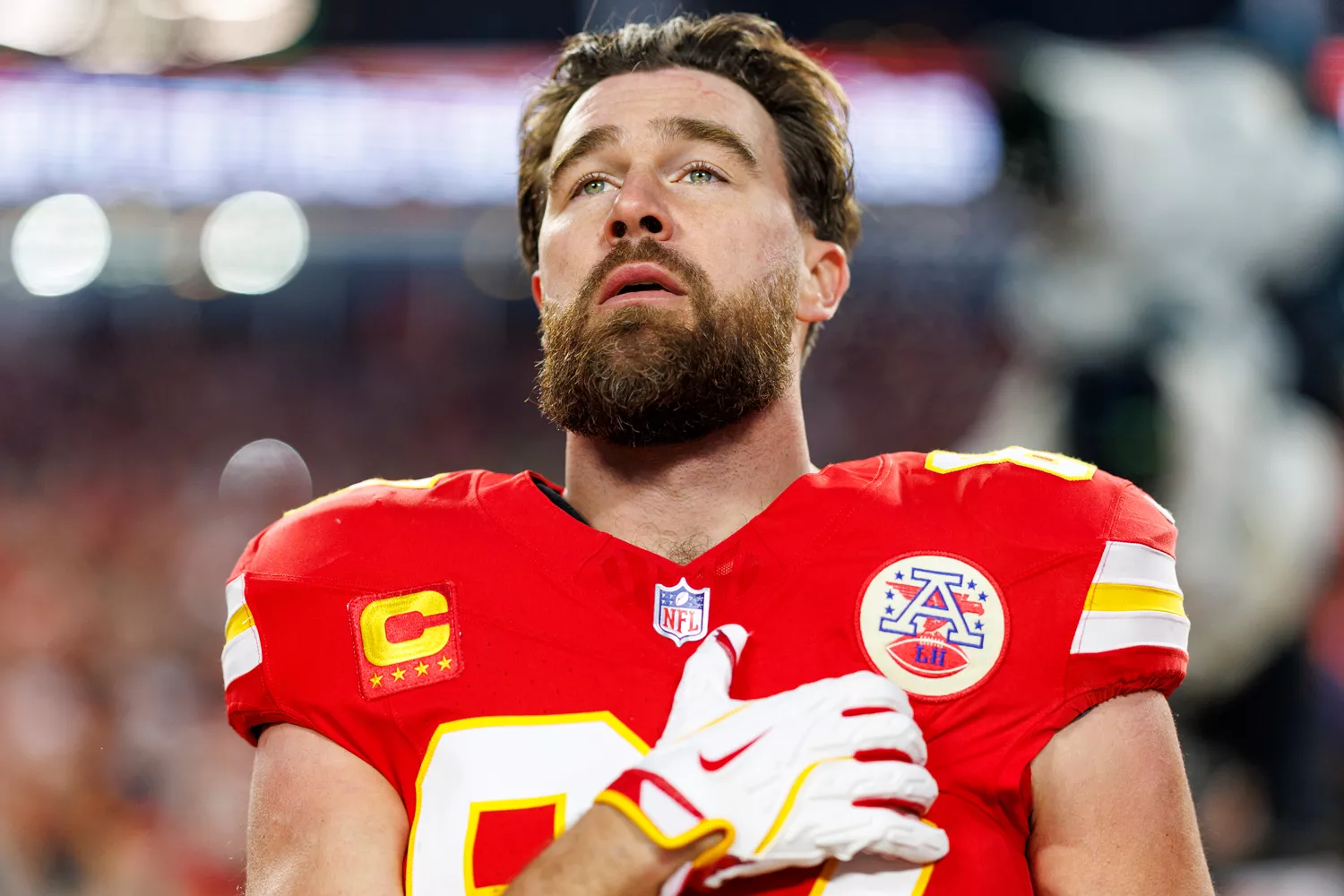 Tight end Travis Kelce #87 of the Kansas City Chiefs stands on the sidelines during the national anthem prior to the AFC Championship game against the Buffalo Bills, at GEHA Field at Arrowhead Stadium on January 26, 2025 in Kansas City, Missouri.