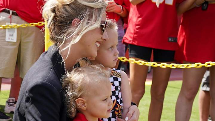 Brittany Mahomes poses with children Bronze and Sterling on field prior to a game between the Kansas City Chiefs and Cincinnati Bengals at GEHA Field at Arrowhead Stadium.