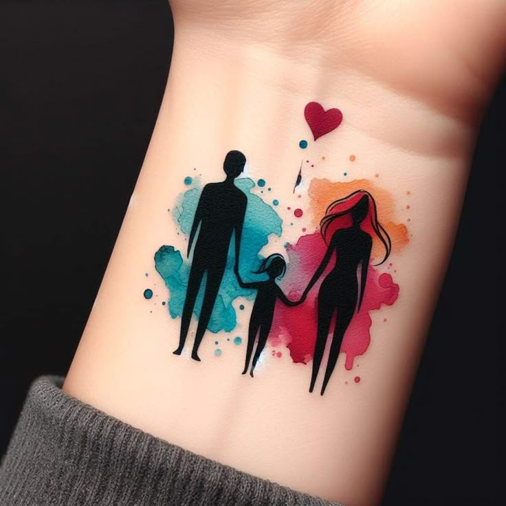 This may contain: a person with a small tattoo on their wrist holding the hand of a child's hand