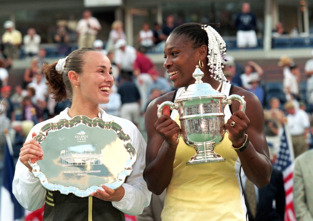 11 Sep 1999: Serena Williams of the USA and Martina Hingis of Switzerland smile and pose with their trophies after their match in the US Open at the USTA National Tennis Center in Flushing Meadows, New York. Williams defeated Hingis 6-3, 7-6 (7-4). Mandatory Credit: Jamie Squire /Allsport