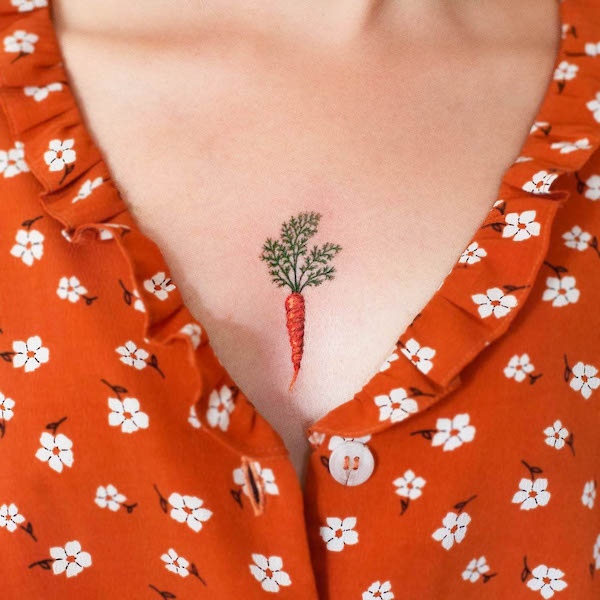 Small cute carrot chest tattoo by @carrot.tattoo