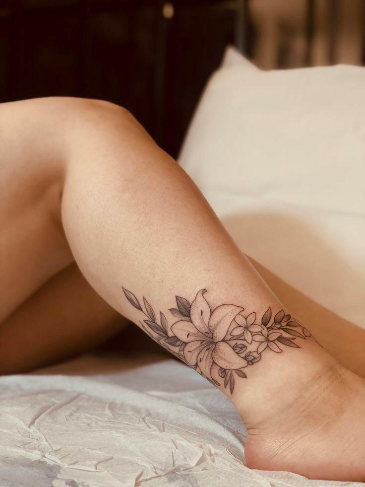 Minimalist, delicate and elegant monochrome flower ankle tattoo