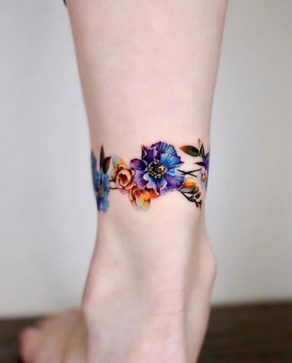 Impressive, unique and colorful galaxy flower ankle tattoo