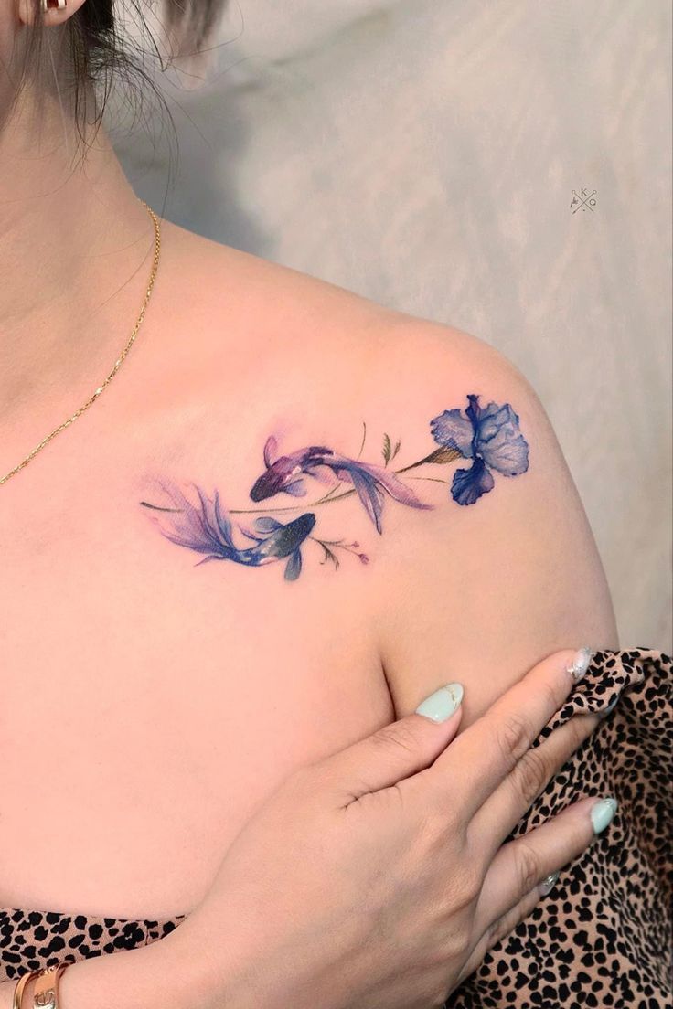 This may contain: a woman with a tattoo on her chest