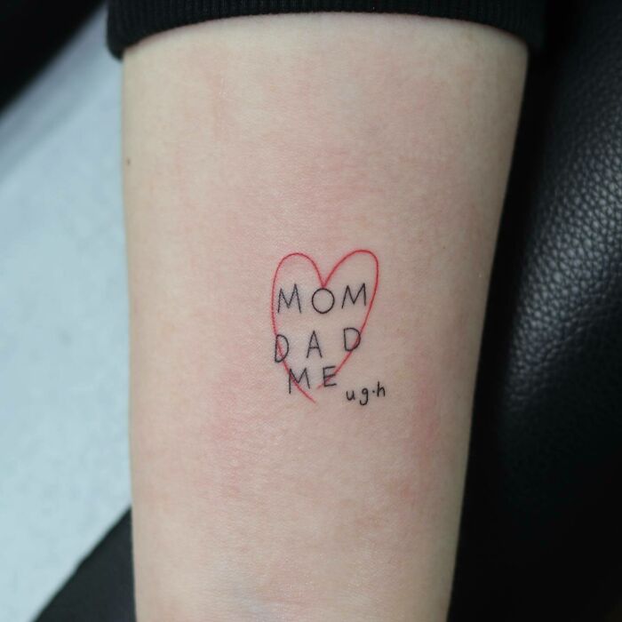 Family tattoo with "Mom, Dad, Me" text inside a red heart, symbolizing unbreakable bonds. Family tattoo with "Mom, Dad, Me" text inside a red heart, symbolizing unbreakable bonds.