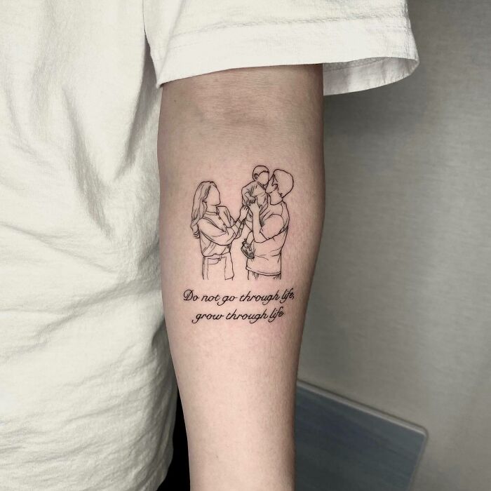 Family tattoo featuring a couple holding a baby, symbolizing unbreakable bonds with a quote about growth. Family tattoo featuring a couple holding a baby, symbolizing unbreakable bonds with a quote about growth.