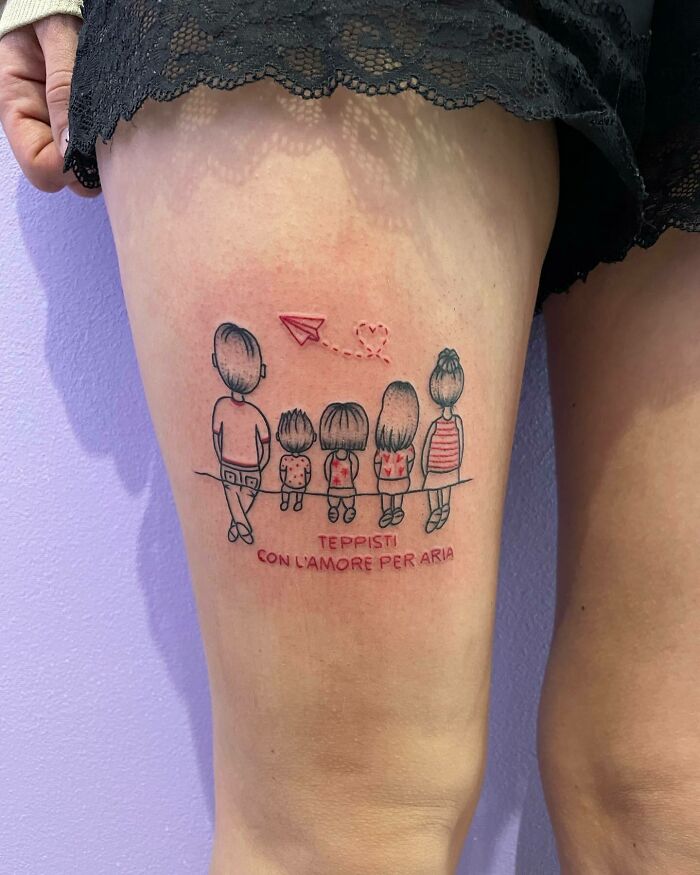 Family tattoo depicting stick figures and a paper airplane on the thigh, symbolizing unbreakable family bonds. Family tattoo depicting stick figures and a paper airplane on the thigh, symbolizing unbreakable family bonds.