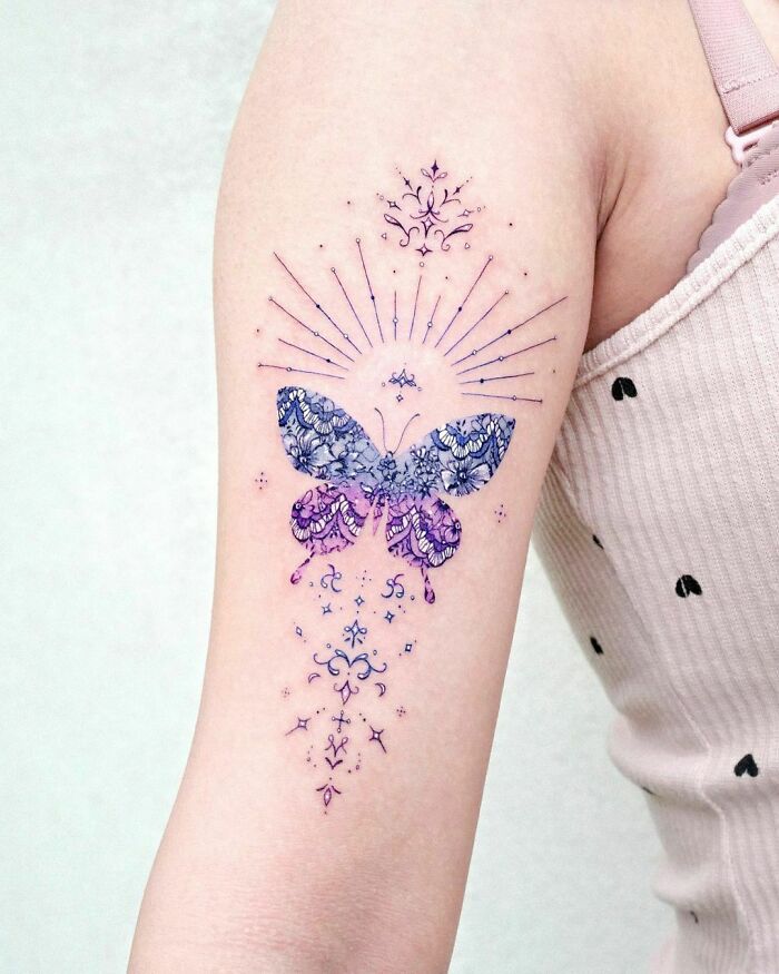 Colorful butterfly tattoo with intricate patterns on an arm. Colorful butterfly tattoo with intricate patterns on an arm.