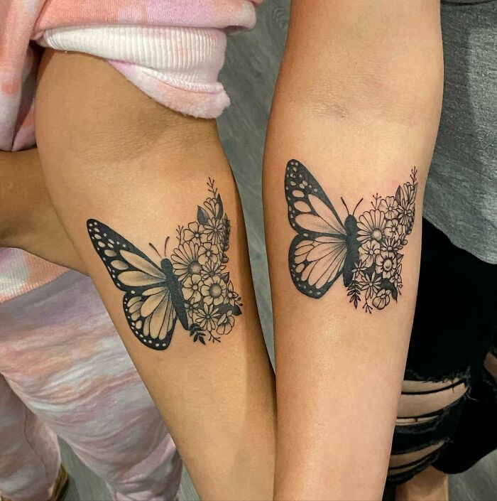 Butterfly tattoos with floral patterns on two forearms. Butterfly tattoos with floral patterns on two forearms.