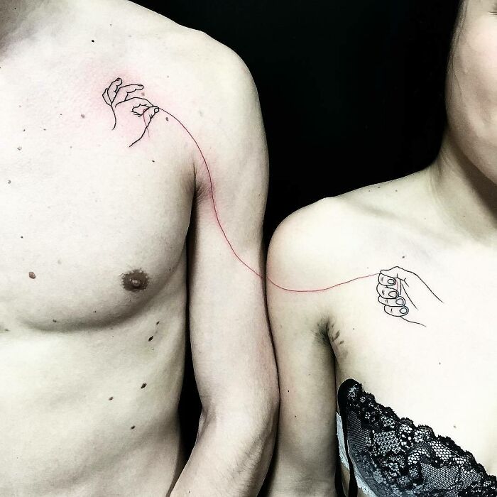 Minimalist family tattoos on two people, connected by a red string, symbolizing unbreakable bonds. Minimalist family tattoos on two people, connected by a red string, symbolizing unbreakable bonds.