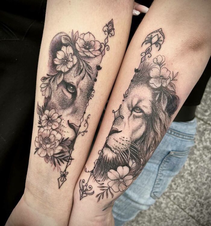 Lion and lioness tattoos on forearms symbolizing unbreakable bonds, adorned with floral designs. Lion and lioness tattoos on forearms symbolizing unbreakable bonds, adorned with floral designs.