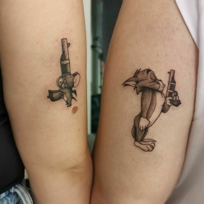 Cartoon character tattoos symbolizing family bonds on two arms. Cartoon character tattoos symbolizing family bonds on two arms.