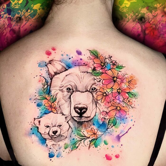 Colorful family-themed tattoo with bears and flowers on back, symbolizing unbreakable bonds. Colorful family-themed tattoo with bears and flowers on back, symbolizing unbreakable bonds.
