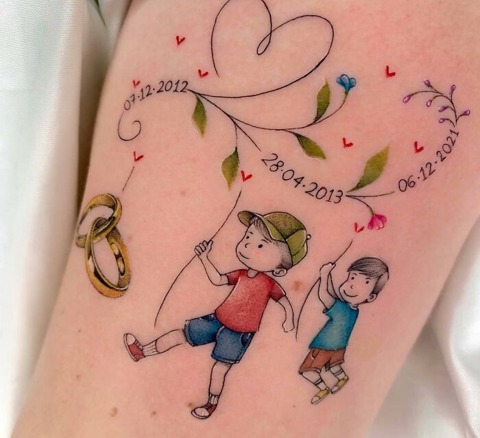 Family tattoo with children, heart design, dates, and wedding rings symbolizing unbreakable bonds. Family tattoo with children, heart design, dates, and wedding rings symbolizing unbreakable bonds.