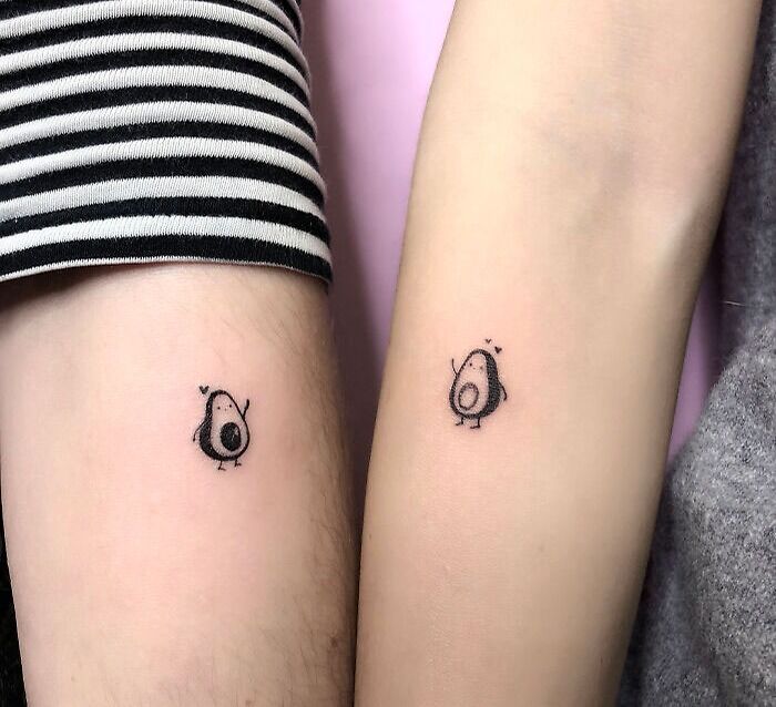 Matching avocado family tattoos on forearms symbolize unbreakable bonds. Matching avocado family tattoos on forearms symbolize unbreakable bonds.