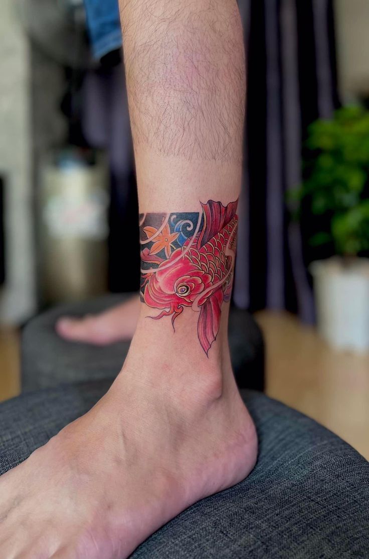 Red carp ankle tattoo stands out, symbol of luck and success