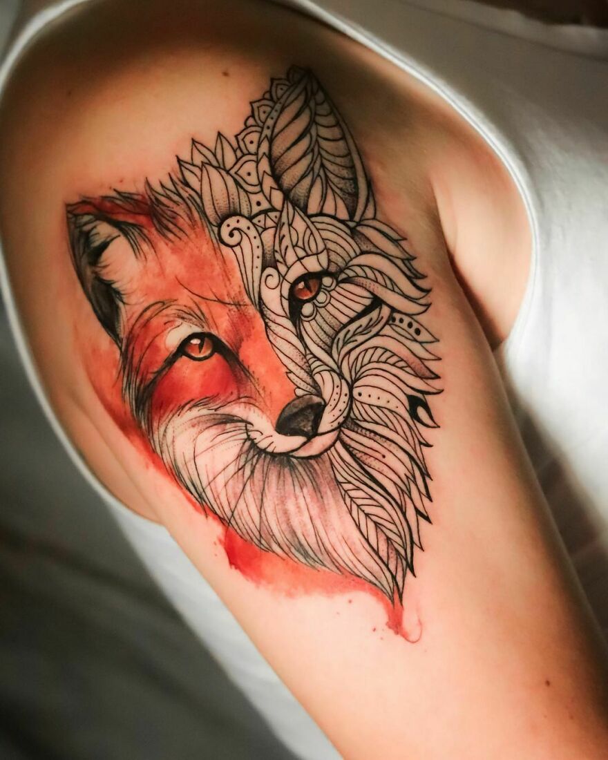 Watercolor tattoo of a fox with geometric patterns on an arm. Watercolor tattoo of a fox with geometric patterns on an arm.