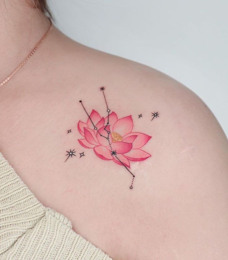 This may contain: a woman with a pink flower tattoo on her shoulder