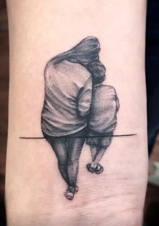 Mother and child tattoo with meaningful design, showing love and attachment.