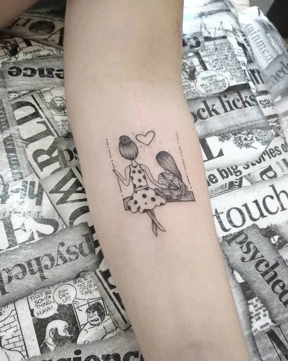 Mother and daughter tattoo on arm with delicate design, showing sacred motherly love.