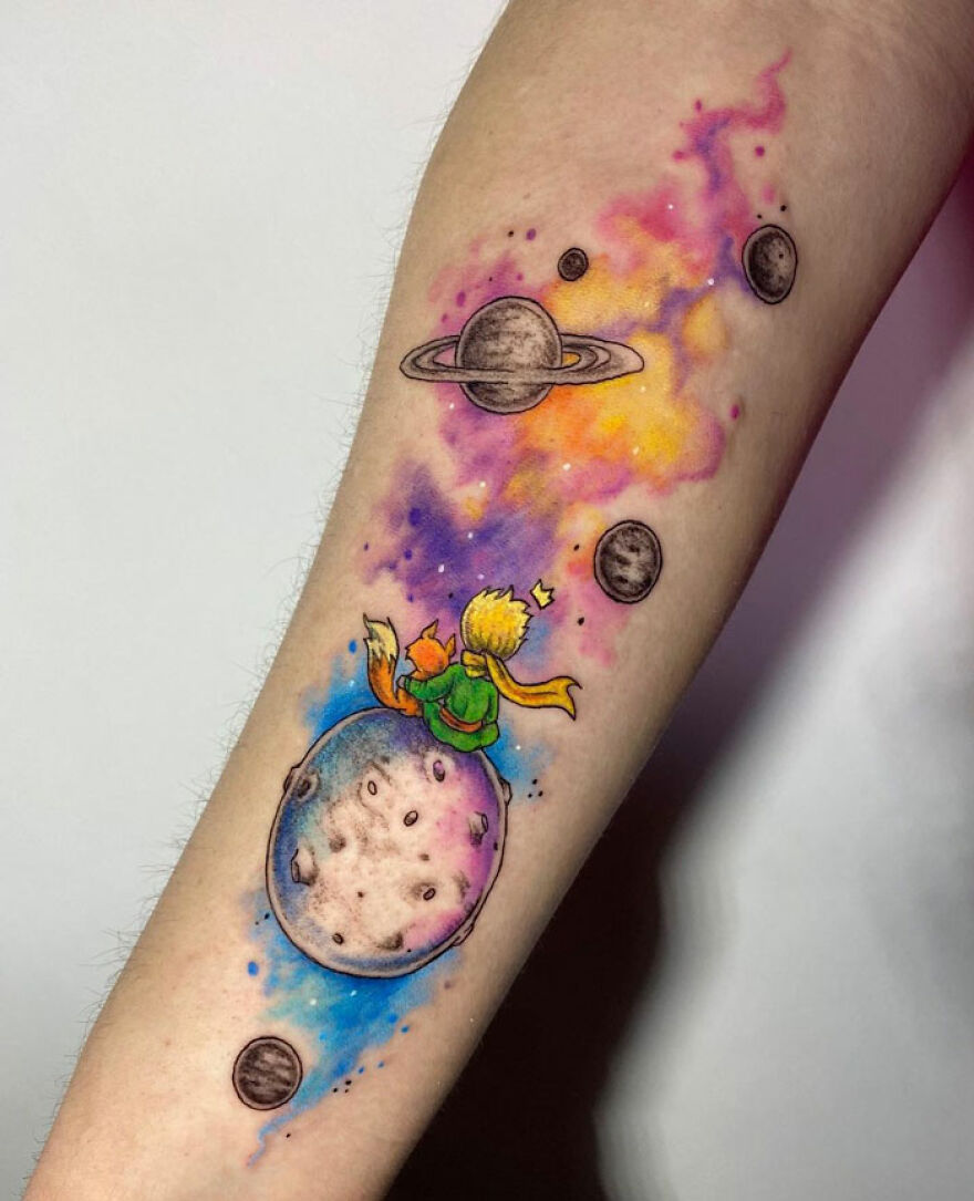 Watercolor tattoo of a little prince and fox on a colorful cosmic background with planets. Watercolor tattoo of a little prince and fox on a colorful cosmic background with planets.