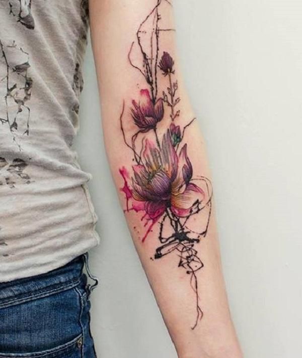 This may contain: a woman's arm with a flower tattoo on the left side of her arm
