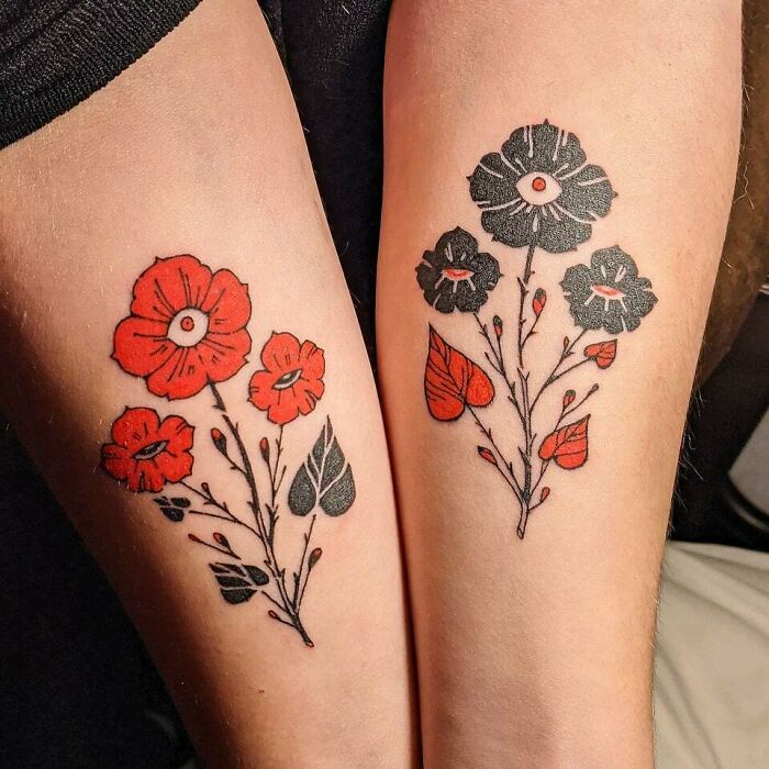 Flower tattoos on arms featuring red and black floral designs, radiating elegance and beauty. Flower tattoos on arms featuring red and black floral designs, radiating elegance and beauty.